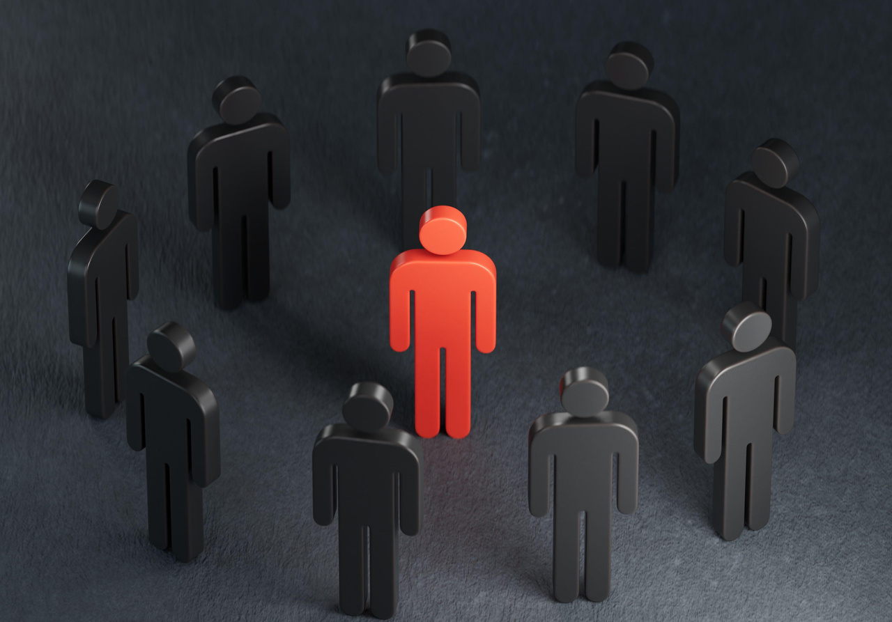 Abstract image of red human figure surrounded by black human figures